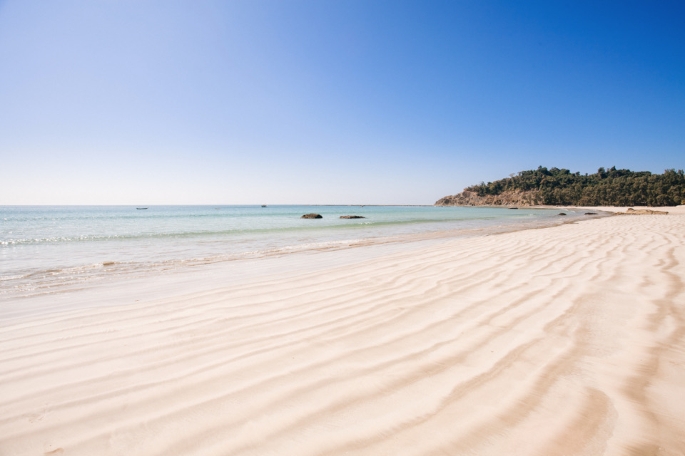 Fine white sand, clear water and a bright blue sky